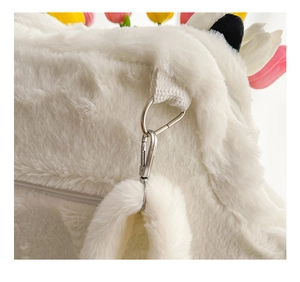 Detail of white plush faux fur bag showing silver metal hook and secure zipper closure