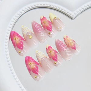 Pink press-on nails with 3D starfish shell texture and pearl flower designs