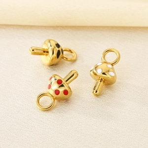 Detailed macro of 18K gold plated mushroom pendants with colorful enamel dots