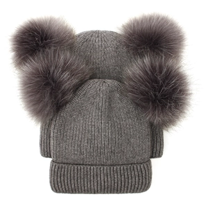Thick ribbed knit winter beanie with double faux fur pom poms in dark grey color