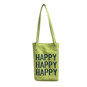 Minimalist green canvas tote bag with bold Happy text print and long shoulder straps