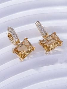 Macro shot of rectangular champagne zircon drop earrings with gold pavé setting