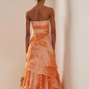 Floral print strapless tiered maxi dress in orange and white abstract pattern for beach resort
