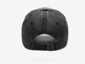 Detail view of the metal adjustable buckle and washed denim fabric on retro baseball cap