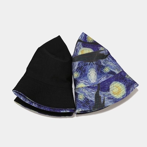 Detail showing reversible bucket hat with Van Gogh Starry Night print and solid black side