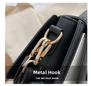Close-up of golden metal hook hardware and premium black leather texture of the shoulder bag