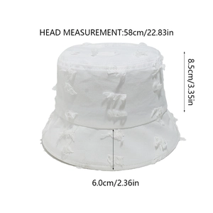 Detailed view of white cotton bucket hat with distressed frayed edges and size specs