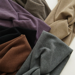 Detail of assorted solid color knotted headbands in soft and thick knit fabric texture