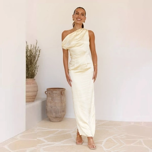 Detail of elegant champagne satin evening dress showing the smooth fabric texture and drape