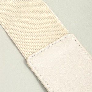 Detail of cream elastic waist belt showing high-quality stitching and woven texture