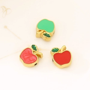 Detailed view of apple shaped enamel pendants in red green and pink for jewelry making