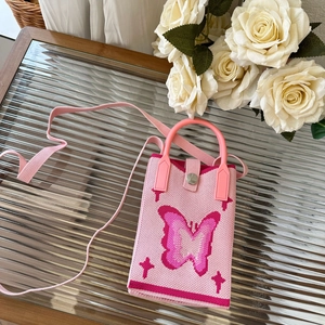Detailed view of pink knitted phone bag with butterfly pattern and silver metal snap button