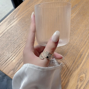Detailed close-up of a gold s925 silver ring with irregular texture on a model's hand