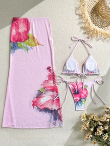 Detailed flat lay of a floral 3-piece bikini set with matching mesh maxi beach skirt