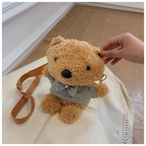 Detail of cute teddy bear plush crossbody bag in brown with a grey hoodie and strap