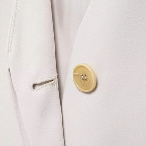 Women's V-neck commuter blazer in beige featuring a classic round yellow button and woven texture
