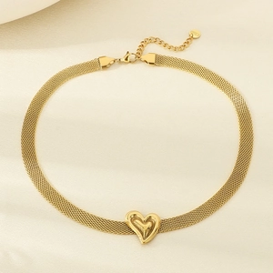 Detail of golden mesh chain necklace with heart pendant and S.STEEL material tag