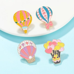 Detailed macro view of colorful enamel hot air balloon badges with gold metallic edges