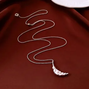 Minimalist 18k gold plated moon pendant necklace on elegant red velvet background