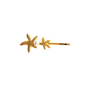 Golden starfish hair clip with elegant pearls on a minimalist stainless steel slide