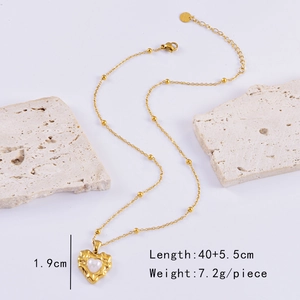 Detail view of gold heart pendant with pearl inlay showing 1.9cm height and 45.5cm chain