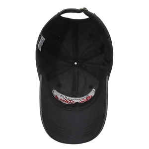 Interior view of black cotton baseball cap showing 100% cotton lining and metal buckle
