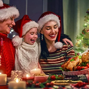 Three generations of women wearing colorful Christmas bead tassel earrings at a festive dinner