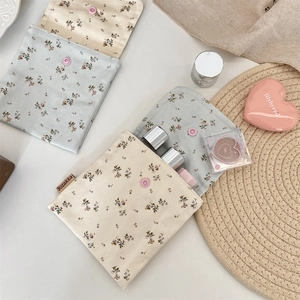 Detailed view of floral cotton pouches with snap buttons for makeup storage