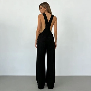 Rear view of black denim overalls for women featuring wide leg cut and soft fabric texture