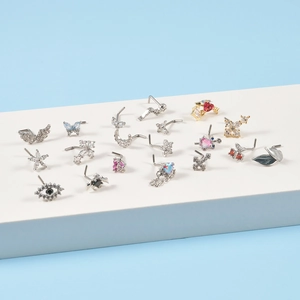 L-shaped surgical steel nose studs featuring butterfly star and moon crystal designs