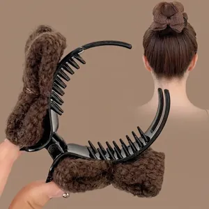 Brown knit bow claw clip with black plastic teeth for elegant hair styling