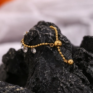 Macro view of adjustable 18K gold plated bead ring with clear crystal waterdrop charms