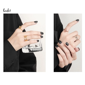 Close-up of anxiety relief spinning beads rings in gold and silver finish on hand