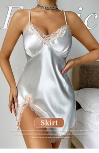 Detail view of silky satin nightgown featuring delicate pink lace trim on side slit