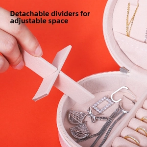 Detail view of pink jewelry box featuring adjustable compartments and removable dividers