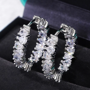 Luxury silver hoop earrings with pear-cut AAA cubic zirconia stones on black velvet