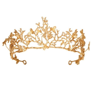 Detailed view of handmade golden bridal crown with crystal leaf and butterfly designs