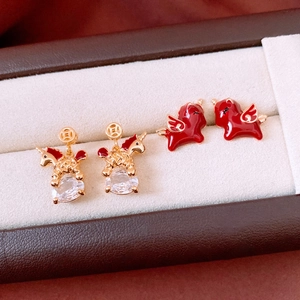 Detailed shot of 18k gold plated unicorn earrings and red enamel Pegasus studs