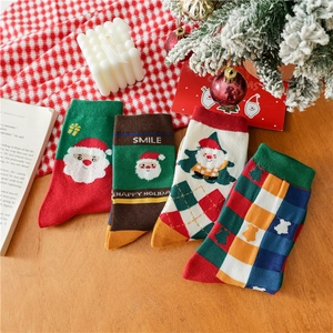Close-up of four pairs of cotton Christmas socks with Santa and tree patterns
