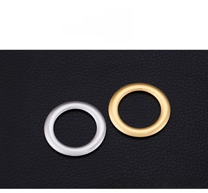 Polished stainless steel round charms in gold and silver finishes on black leather