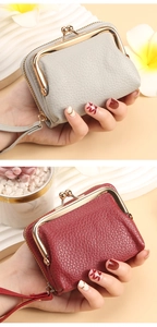 Detail showing red and grey lychee grain leather card wallets with gold kiss lock frame