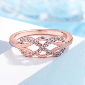 Elegant rose gold infinity ring with sparkling white cubic zirconia stones in macro view