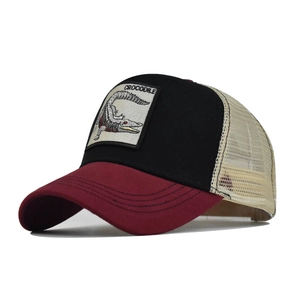 Detail view of cotton trucker hat with mesh back and crocodile embroidery patch