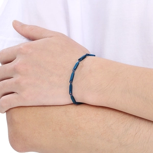 Close-up of minimalist blue geometric link bracelet on wrist with a modern design
