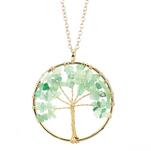 Detail of handmade gold wire-wrapped Tree of Life pendant with green crystal stones