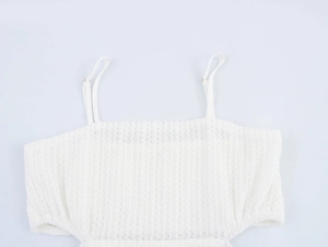 Detail of white mesh crop top with adjustable spaghetti straps and crochet texture
