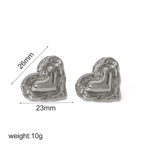 Textured 18k gold heart-shaped earrings with diamond accents and dimensions measurement