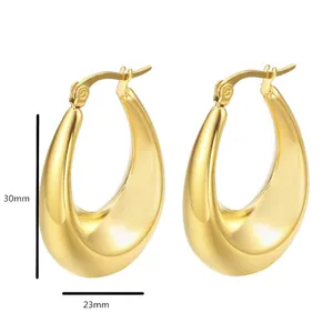 Detail of chunky gold drop hoop earrings in stainless steel with 30mm height and 23mm width