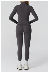 Back view of a slim fit grey yoga set showing high waist leggings and long sleeve top