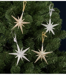 Detail of champagne and silver star ornaments with glitter on Christmas tree branches